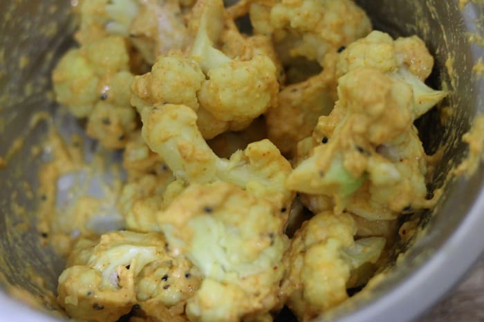 batter coated cauliflower ready to be fried