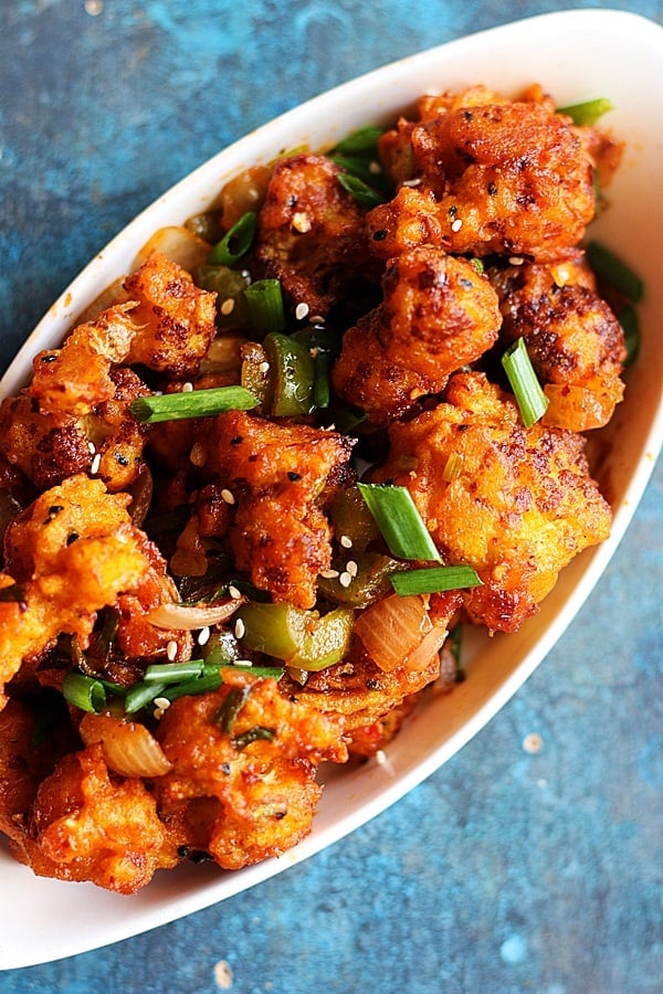 crispy restaurant style dry gobi manchurian served in a ceramic white bowl