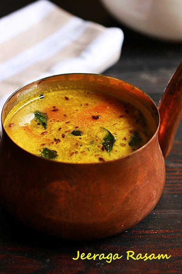 closeup shot of jeera rasam in a copper sauce pan