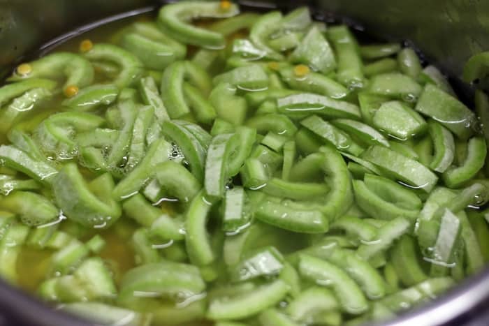 Water added to snake gourd for pressure cooking.