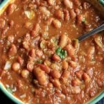 Rajma masala served in a enamel bowl with a spoon