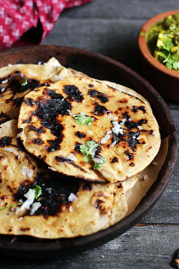 smoky charred tandoori rois served in a wooden plate.