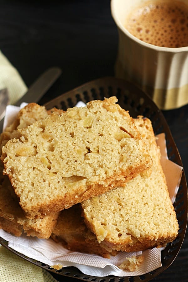 Closeup shot of moist and soft eggless apple cake served with tea