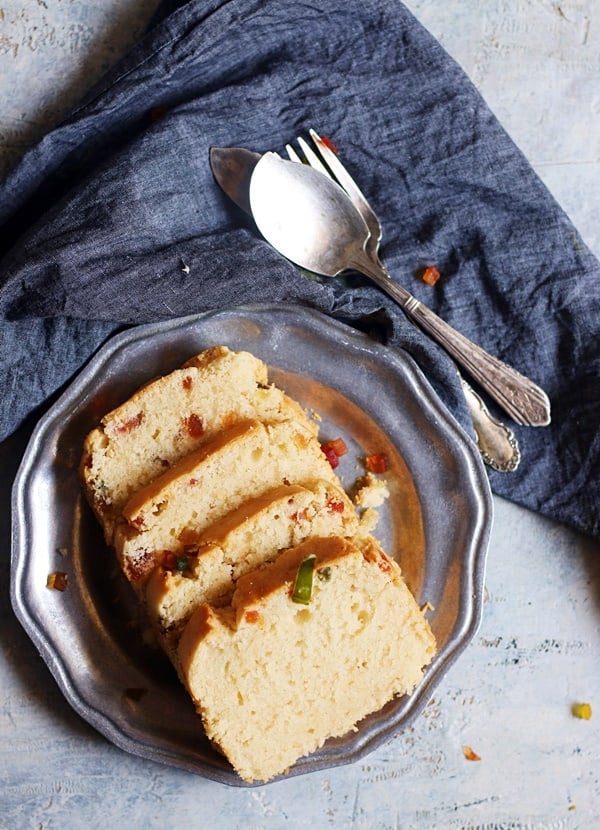 four slices of egg free cream cheese cake placed on a metal plate with fork and spoon