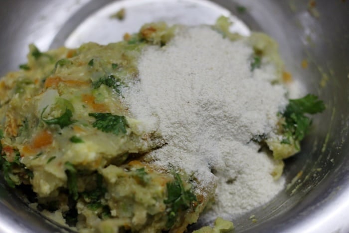 adding rice flakes crumbs to mashed veggies for veg nuggets recipe