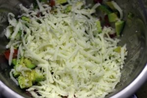 Grated cheese added to avocado mix