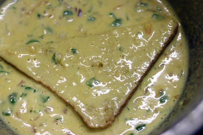Dipping bread in chickpea batter for Savory vegan french toast recipe
