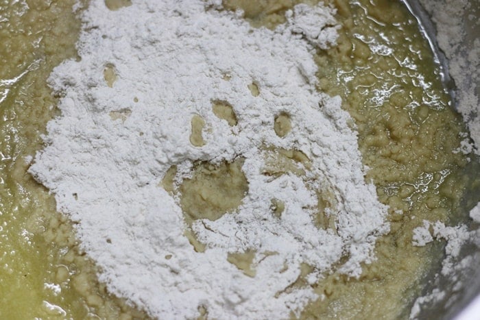 creaming ghee and powdered sugar together in a mixing bowl.