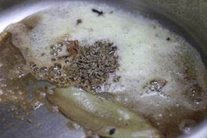 frying cumin seeds, bay leaf in oil