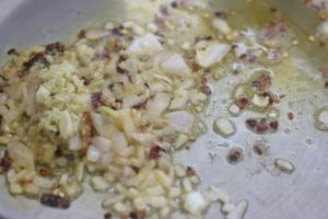 sautéing chili flakes, ginger garlic and onions in sesame oil