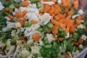 chopped vegetables added to sesame oil to make veg fried rice