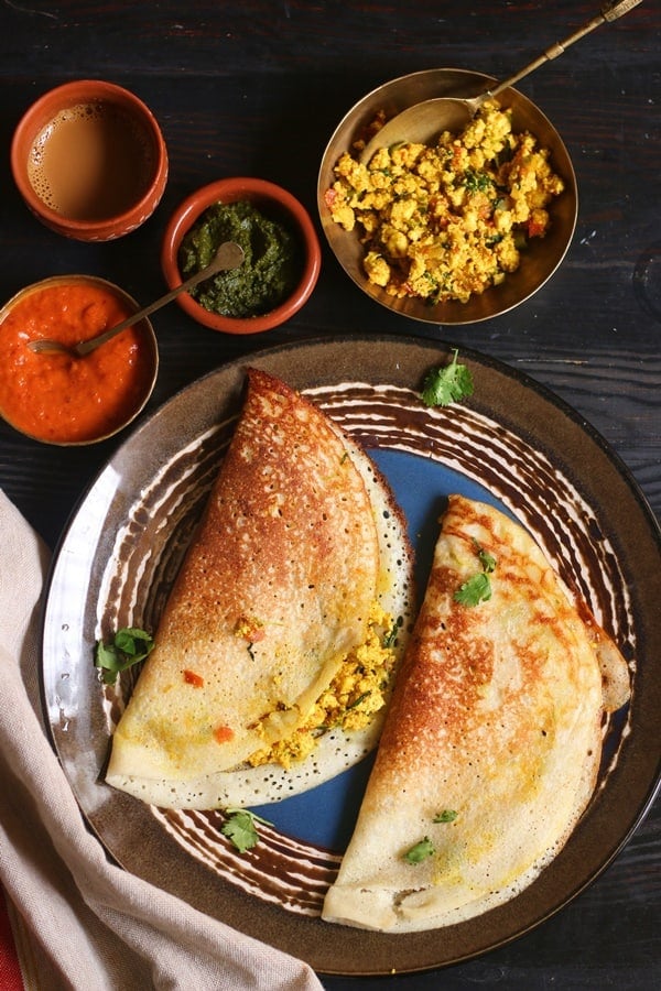 Paneer dosa for breakfast served in a blue plate with chutney, sambar and coffee