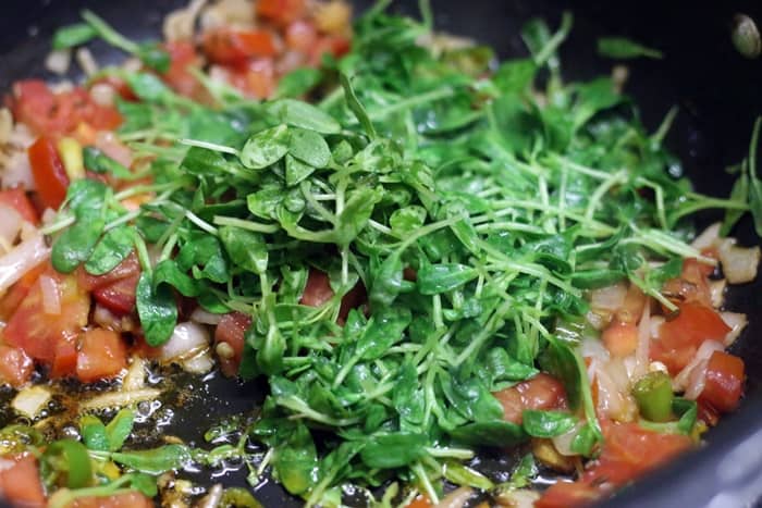 Sautéing tomatoes and fenugreek leaves 