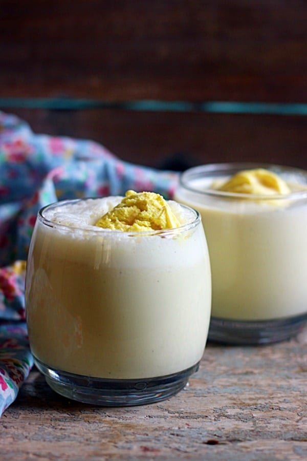 Chilled badam shake served with a scoop of almond ice cream in glass