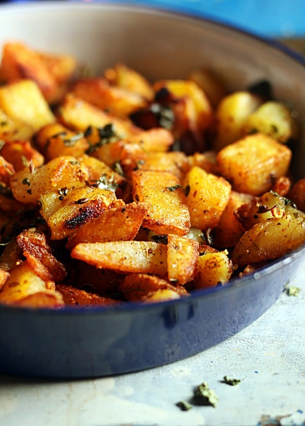 Closeup shot of pan roasted potatoes in a blue enamel pan