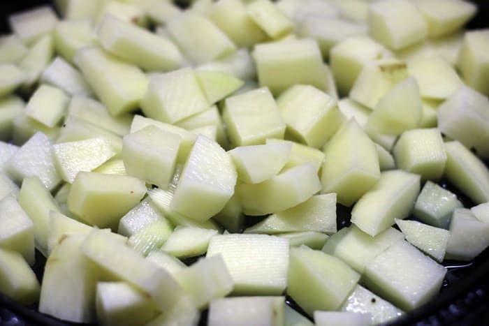 sauteing cubed potatoes in oil for making roasted potatoes