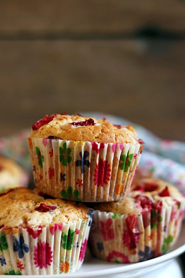 Stack of egg free strawberry muffins on a white plate served for snacks