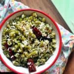 Beans poriyal served in a red rimmed bowl for lunch