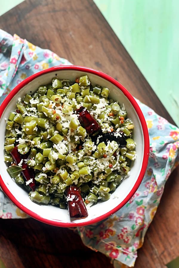 Beans poriyal served in a red rimmed bowl for lunch