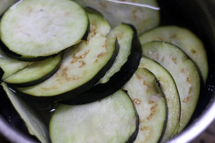Eggplants in salted water to make brinjal chutney