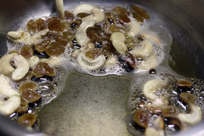 Frying cashews and raisins in ghee for making pineapple kesari