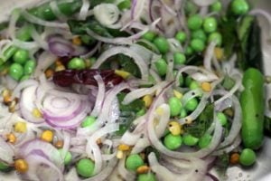 sautéing onions and peas in oil