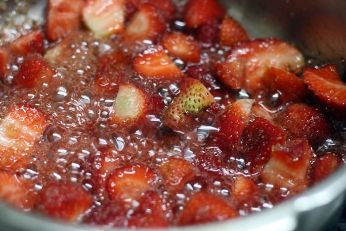 Strawberry sauce thickening in a pan