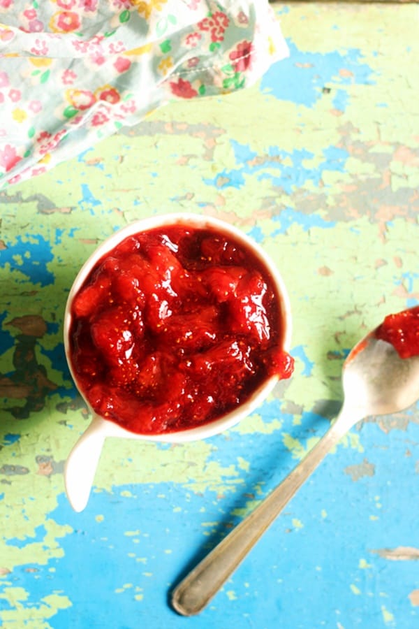 Overhead shot of strawberry sauce served with a spoon