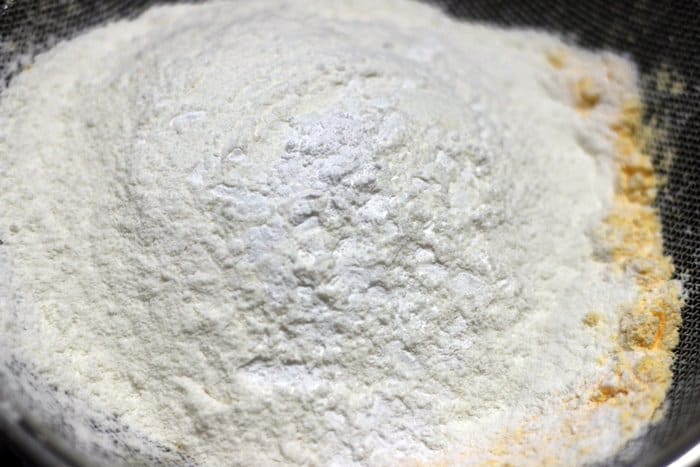 sifting flour, custard powder and salt for making custard creams recipe