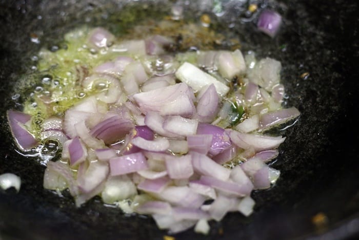 Sauteing onions for making gajar matar recipe