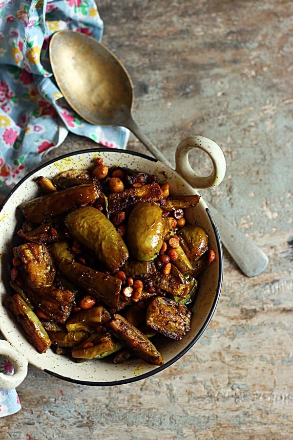 overhead shot of easy brinjal fry or kathirikai fry served in a ceramic pan