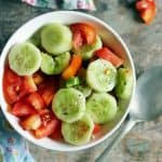 This cucumber tomato salad is so delicious with fresh crispy cucumbers, sweet tomatoes and a mild dressing. It is a summer staple and pairs beautifully with any summer meals