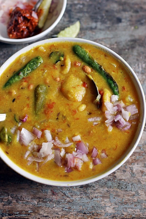 Closeup shot of Gujarati dal dhokli served in a white bowl 