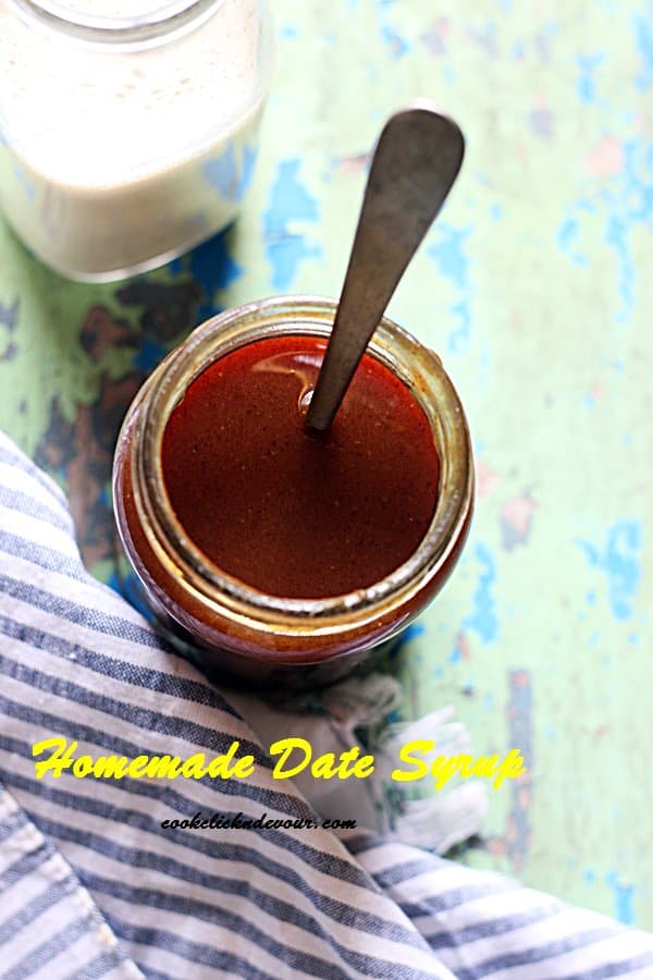 Overhead shot of homemade date syrup served with milk in a bottle.