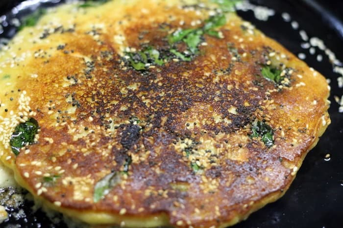 cooking handvo in a pan