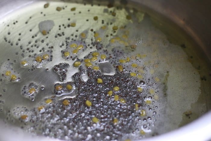 tempering mustard and methi seeds in sesame oil