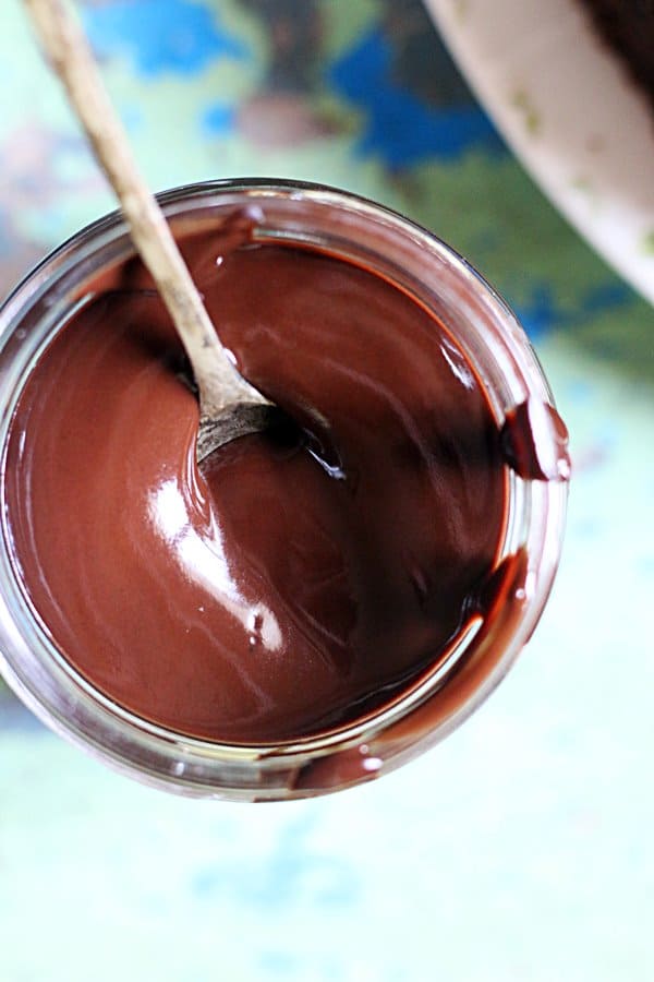 closeup shot of homemade chocolate syrup served with a spoon