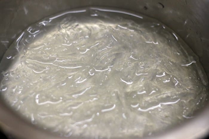 cooking soaked agar agar in low flame for making tender coconut pudding 