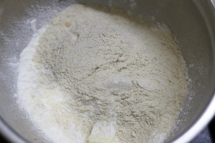chilled butter and flour added to a mixing bowl for pizza crackers