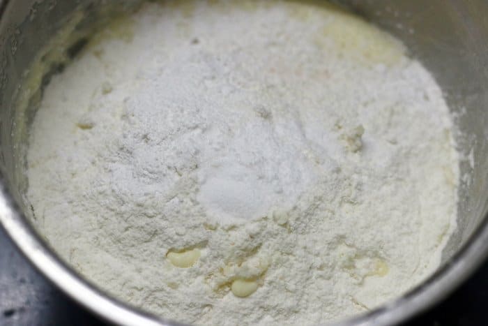 dry ingredients sifted over wet ingredients for making butter cake recipe 