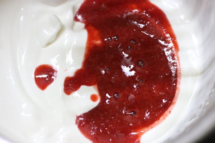 strawberry puree added to whipped cream