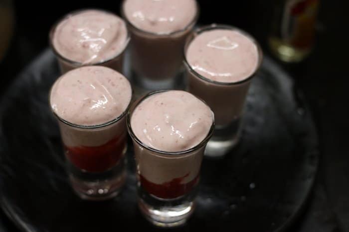 strawberry mousse divided among serving glasses