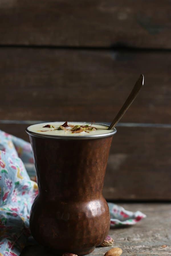 Pinjabi sweet lassi served in copper tumbler with a big spoon to dig in!