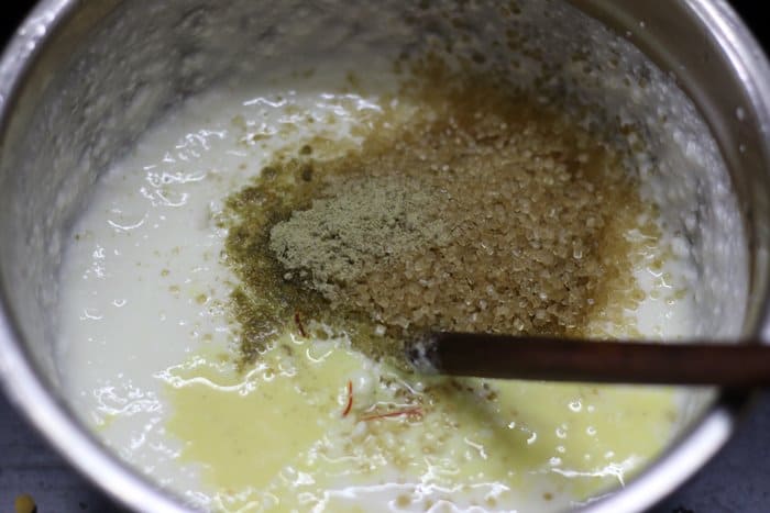 sugar,saffron and cardamom added to curd for making lassi