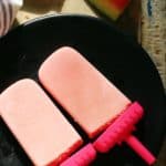 creamy watermelon popsicles served on ablack plate for dessert