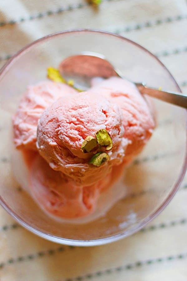 Homemade watermelon ice cream served in dessert bowl with a spoon