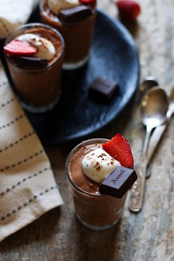 A serving of delicious and easy chocolate mousse with whipped cream and chocolate topping