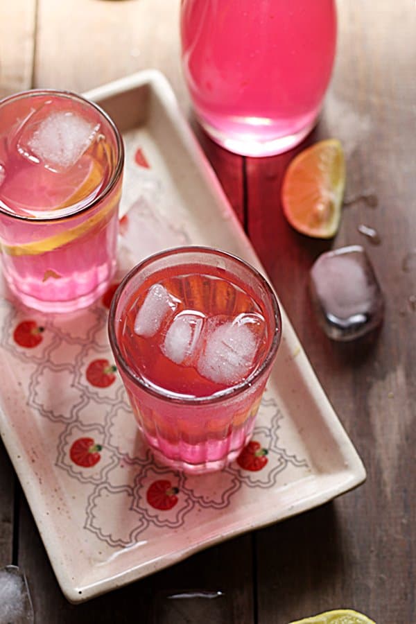 Rose lemonade served in a small glass.