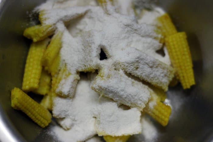 blanched baby corns tossed in flours
