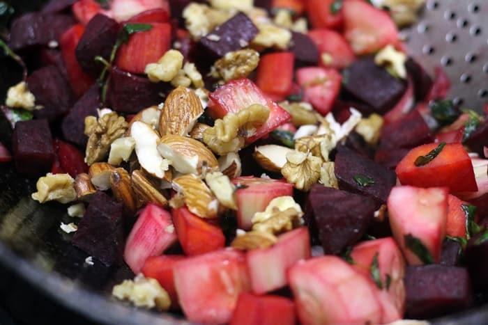 adding nuts to beetroot salad